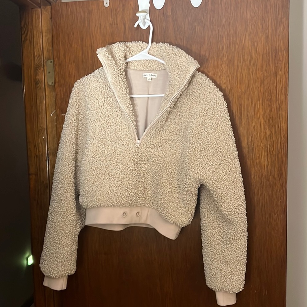 Tan, soft, cropped sweater with a zipper upfront.